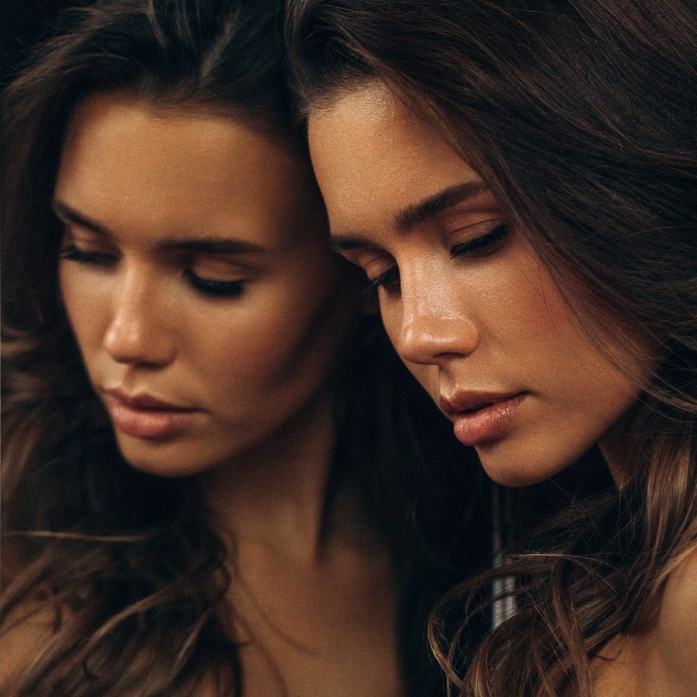 Woman gazing thoughtfully with soft lighting.