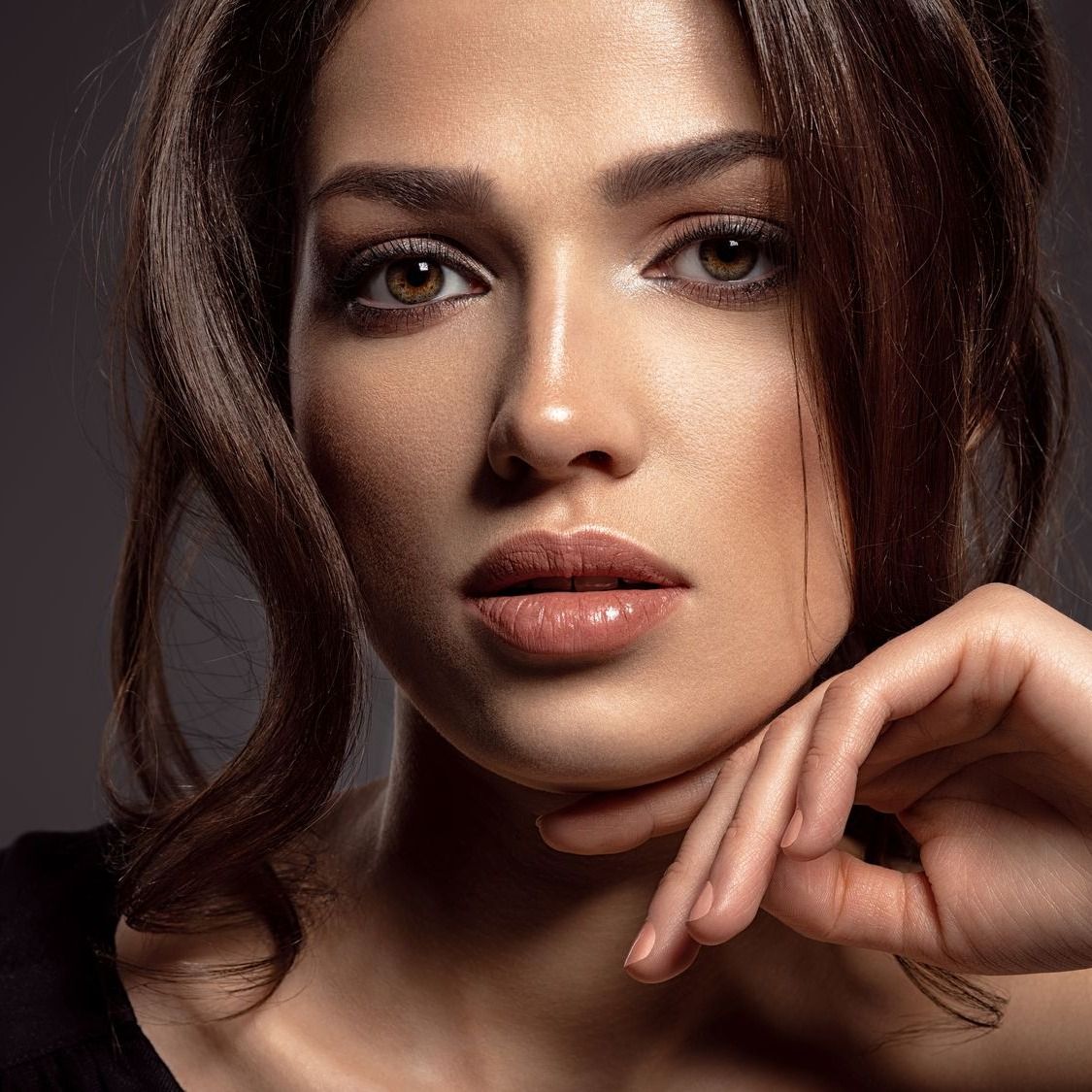 Close-up portrait of a woman with soft features.