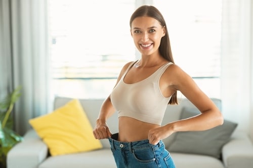 Slim,Woman,Wearing,Old,Oversized,Jeans,After,Great,Weight,Loss