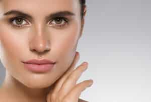 Close-up of a beautiful woman with smooth, bright skin after getting DENSITY RF facial treatment.